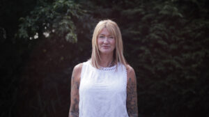 Karen Slater wearing white top standing in the garden