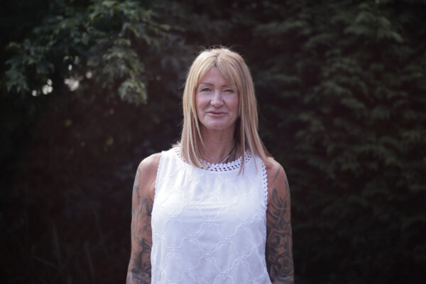 Karen Slater wearing white top standing in the garden