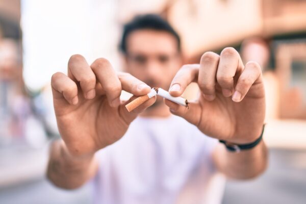 Man holding cigarette snapped in half